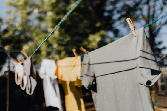 assorted clothes hanging on washing line