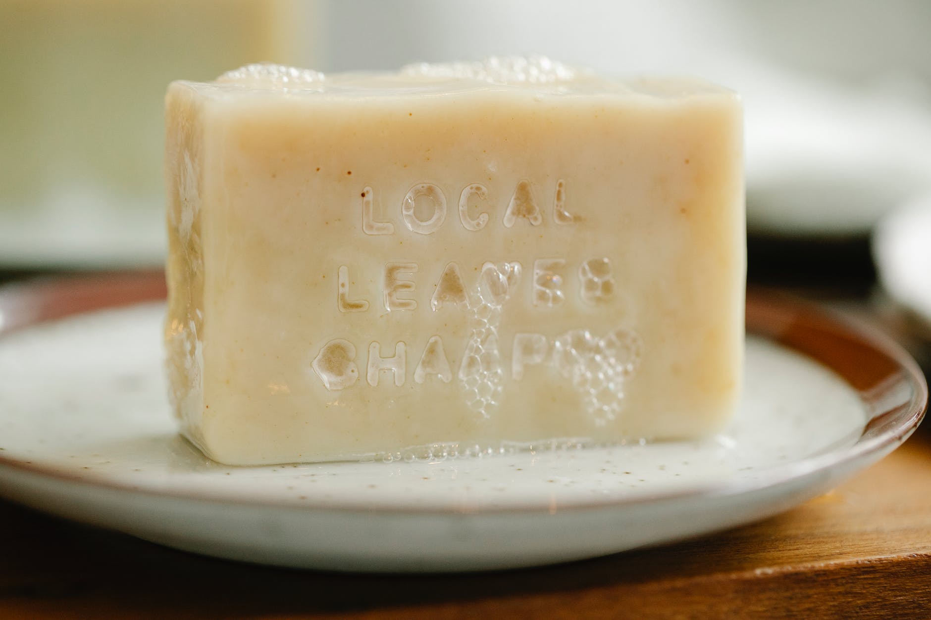 foamy beige soap on ceramic plate